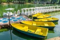 White Swan Pedal Boats and Yellow Rowing Boat pier in public park at Bangkok, Lumpini Park is an inner-city haven of tranquility Royalty Free Stock Photo