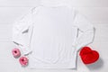 White sweatshirt mockup. Valentines Day concept shirt, gift box heart shape on wooden background. Copy space, template blank front