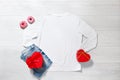 White sweatshirt mockup. Valentines Day concept shirt, gift box heart shape on wooden background. Copy space, template blank front