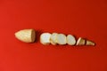 White sweet potato pieces slices protein food on isolated red background