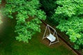 white swing bench chair under green tree Royalty Free Stock Photo