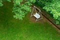 white swing bench chair under green tree Royalty Free Stock Photo