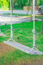 White swings, empty loop in playground