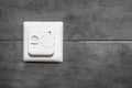 White switch and underfloor heating thermostat on a gray concrete wall in a modern bathroom Royalty Free Stock Photo