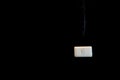 A white switch is used to turn the lamp on and off on a black wall Royalty Free Stock Photo