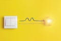 White switch and yellow glowing star with wires phase, zero, ground, uniqueness concept. Idea, innovation, creativity concept Royalty Free Stock Photo