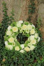 White sympathy wreath near a tree Royalty Free Stock Photo