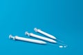 White syringe medical kit set of botox or filler for beauty clinic concept on blue background with surgery equipment. 3D