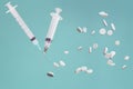 white syringes and tablets on a green background Royalty Free Stock Photo