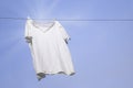 White T-shirt on clothesline against blue sky Royalty Free Stock Photo