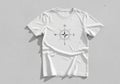 White t-shirt featuring a black compass rose design centered on the Royalty Free Stock Photo