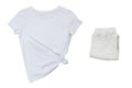 White t-shirt and folded pants isolated on white background top view, tshirt and pants