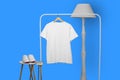 White t-shirt hanging on rack display isolated on plain background Royalty Free Stock Photo