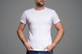 White t-shirt on a young man template. Gray background. Royalty Free Stock Photo