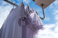 White T-shirts on clothesline against blue sky. Royalty Free Stock Photo