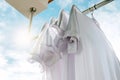 White T-shirts on clothesline against blue sky. Royalty Free Stock Photo