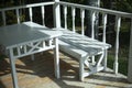 White table and bench on the summer veranda. Wooden furniture. Stylist of the 19th century.