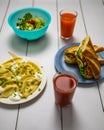 White table with black lines with dishes and drinks like salad dumplings