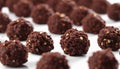 A white table with a bunch of chocolate covered balls Royalty Free Stock Photo