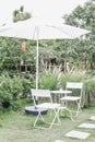 White Table,chair set and patio umbrella for relaxing with nature atmosphere in the outdoor garden the tree shade with the afterno Royalty Free Stock Photo