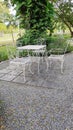 White table and chairs in beautiful garden Royalty Free Stock Photo