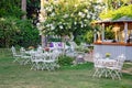 White table and chairs in beautiful garden. Outdoo Royalty Free Stock Photo