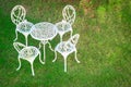 White table and chairs in a garden Royalty Free Stock Photo