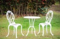 White table and chairs in a garden Royalty Free Stock Photo