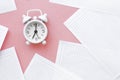 White table clock, alarm clock on a bright background, top view. Break at work in the office. Paper, flatlay Royalty Free Stock Photo
