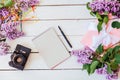 On the white table lilac, gift, notebook Royalty Free Stock Photo