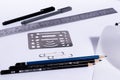 White table with roll paper. Pencils and pens with rulers and clips on an architect`s desk. Royalty Free Stock Photo