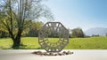 White table shelf with bagua and pebble stone, park meadow with green grass and tree, zen concept interior design, feng shui