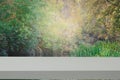 White table stand on a background of trees and river.