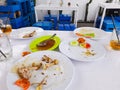 Leftover food, plates and glasses on the table used for family meals. Royalty Free Stock Photo