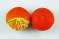 two tangerine fruits on a white background with partially peeled peel