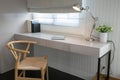 White table with wooden chair and books in modern working area