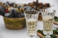 white tablecloth, two champagne glasses on a long stem. Carbonated white wine. Selective focus, plates and snacks. The concept of