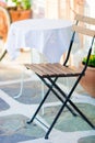 White tables with chair at summer empty open air cafe in Greece