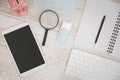 White Tablet With Blank Screen, laptop and accessories and office stuff On Wooden Desk With Stationary Objects , Top View,Travel c Royalty Free Stock Photo