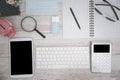 White Tablet With Blank Screen, laptop and accessories and office stuff On Wooden Desk With Stationary Objects , Top View,Travel c Royalty Free Stock Photo