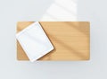 White Tablet Computer on Light Wood Surface with Sunlight Shadows technology device Royalty Free Stock Photo
