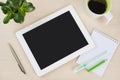 White tablet pc with notes, pen and coffee cup on desk Royalty Free Stock Photo