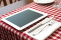 Tablet PC with Fork and Knife on Red Checked Tablecloth Ã¢â¬\' Modern Dining Concept Royalty Free Stock Photo