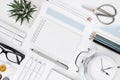 White tabletop with office supplies and blank notebook in center Royalty Free Stock Photo