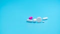 White tablets pills on blur pink tablet pill and blue background. Pharmacy banner. Pharmaceutical industry. Health insurance Royalty Free Stock Photo