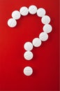 White tablets on red background as question mark Royalty Free Stock Photo