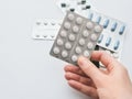 20 white tablets in a silver blister in hand close-up. Copy space on a white background Royalty Free Stock Photo