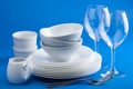 White tableware over blue background Royalty Free Stock Photo