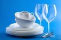 White tableware over blue background Royalty Free Stock Photo