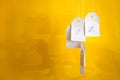 White tags with the percent sign hang on strings on a yellow background with shadows. Commerce, discount, sale, trade offer. Copy Royalty Free Stock Photo